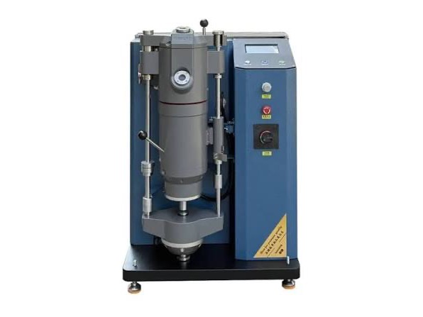 Vacuum pressure casting machine with its cylindrical melt chamber, control panel and floor-standing cabinet